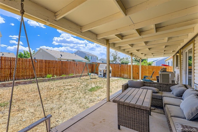 4932 Jasper St, Denver, CO 80239 - fenced backyard with outdoor lounge area, a patio, and a storage shed