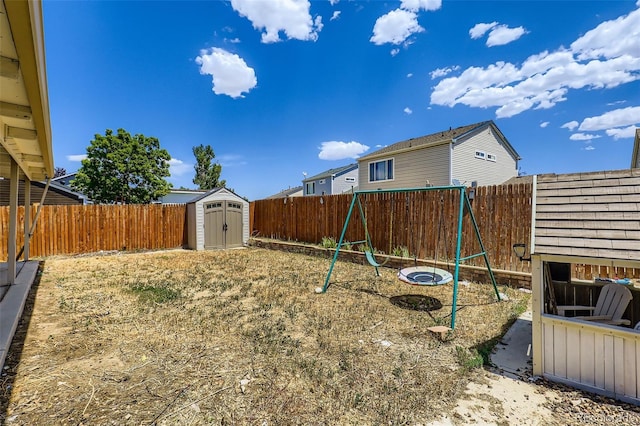 4932 Jasper St, Denver, CO 80239 - fenced backyard with a storage shed and a playground