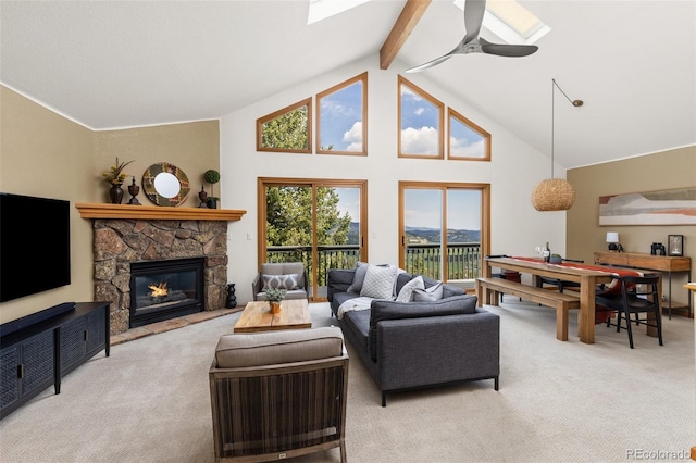 6882 Snowshoe Trl, Evergreen, CO 80439 - living room featuring carpet, a ceiling fan, beam ceiling, a fireplace, and high vaulted ceiling