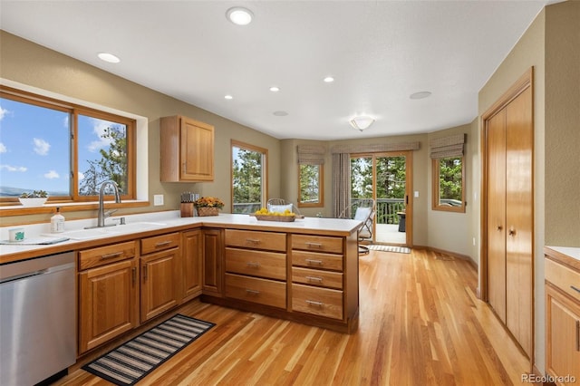 6882 Snowshoe Trl, Evergreen, CO 80439 - kitchen with dishwasher, a peninsula, light countertops, light wood-style flooring, and recessed lighting