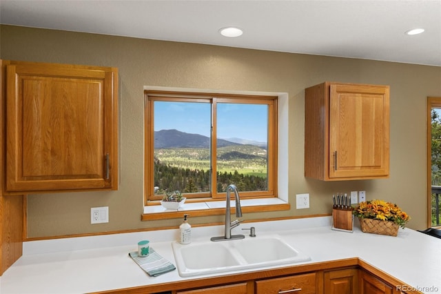 6882 Snowshoe Trl, Evergreen, CO 80439 - kitchen with plenty of natural light, light countertops, a mountain view, and recessed lighting