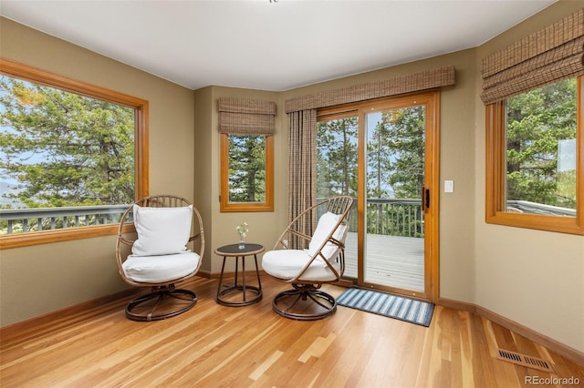 6882 Snowshoe Trl, Evergreen, CO 80439 - living area with healthy amount of natural light and wood finished floors