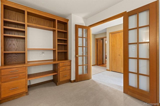 6882 Snowshoe Trl, Evergreen, CO 80439 - interior space featuring built in study area, french doors, light colored carpet, and light tile patterned flooring