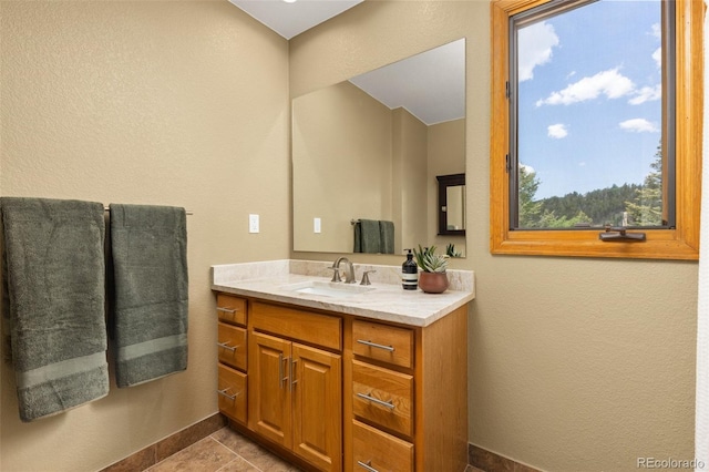 6882 Snowshoe Trl, Evergreen, CO 80439 - bathroom featuring vanity, a textured wall, and tile patterned flooring