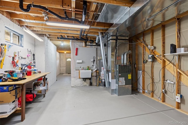 6882 Snowshoe Trl, Evergreen, CO 80439 - unfinished below grade area with water heater, a workshop area, and heating unit
