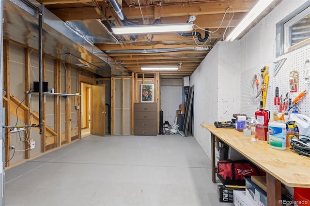 6882 Snowshoe Trl, Evergreen, CO 80439 - unfinished basement featuring a workshop area