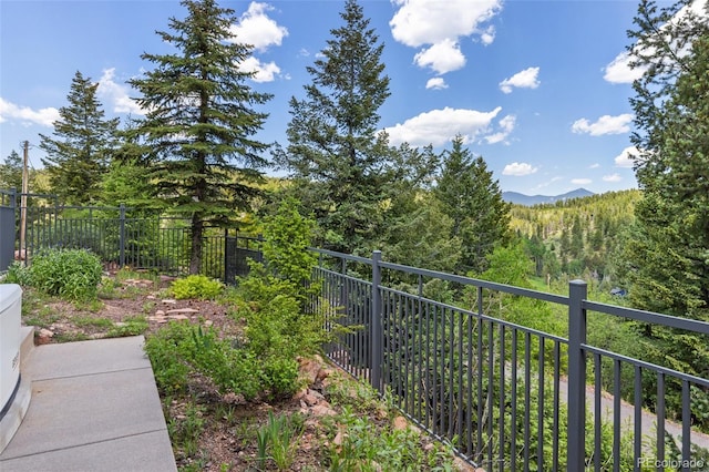6882 Snowshoe Trl, Evergreen, CO 80439 - view of yard featuring a view of trees and a balcony