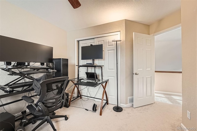 home office featuring light carpet and ceiling fan