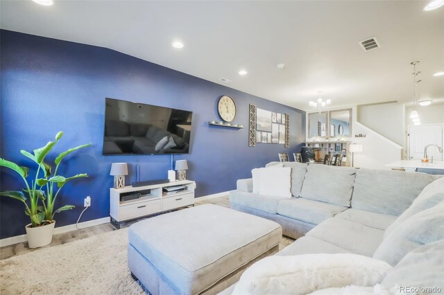 4026 Tiberias Pt, Colorado Springs, CO 80916 - living room with light hardwood / wood-style floors, sink, and a chandelier