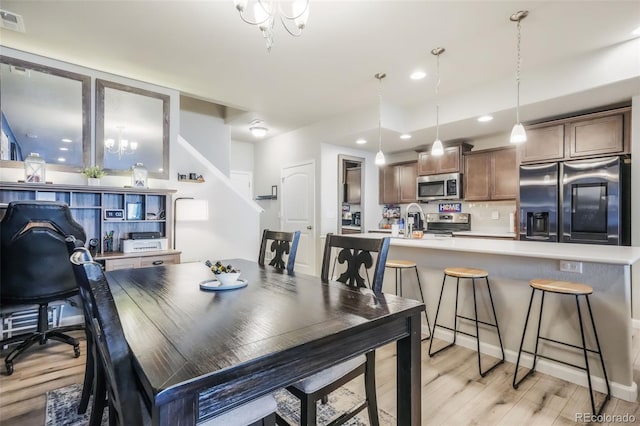 4026 Tiberias Pt, Colorado Springs, CO 80916 - dining room featuring light hardwood / wood-style flooring and a notable chandelier