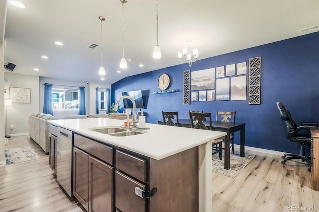4026 Tiberias Pt, Colorado Springs, CO 80916 - kitchen with a kitchen island with sink, sink, hanging light fixtures, light hardwood / wood-style flooring, and a notable chandelier