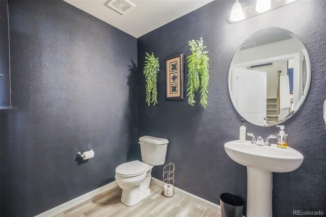 4026 Tiberias Pt, Colorado Springs, CO 80916 - bathroom with hardwood / wood-style flooring, toilet, and sink