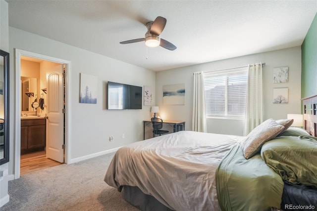 4026 Tiberias Pt, Colorado Springs, CO 80916 - bedroom with ceiling fan, light colored carpet, sink, and ensuite bath