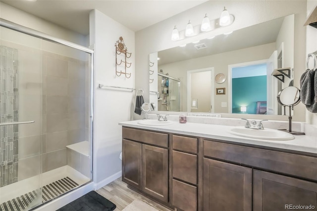 4026 Tiberias Pt, Colorado Springs, CO 80916 - bathroom featuring hardwood / wood-style floors, vanity, and a shower with door
