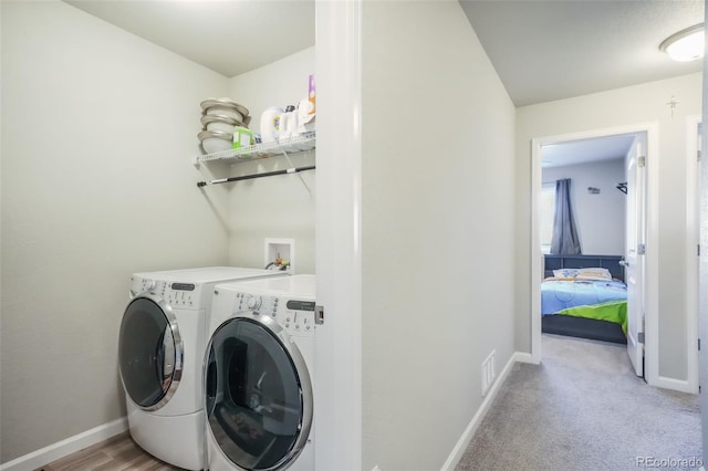 4026 Tiberias Pt, Colorado Springs, CO 80916 - laundry area with light carpet and washer and clothes dryer