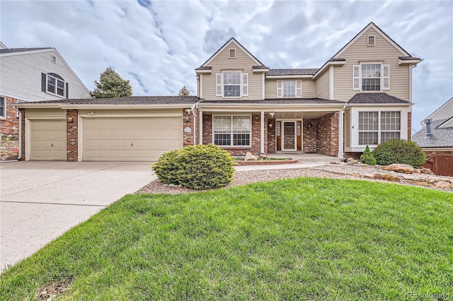 view of front of property featuring a front yard, a garage, and covered porch