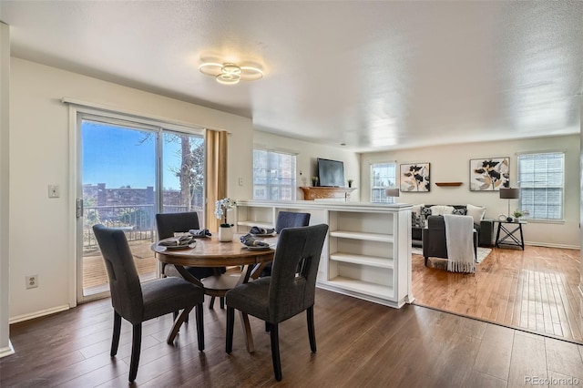 dining area featuring a healthy amount of sunlight, baseboards, and dark wood finished floors