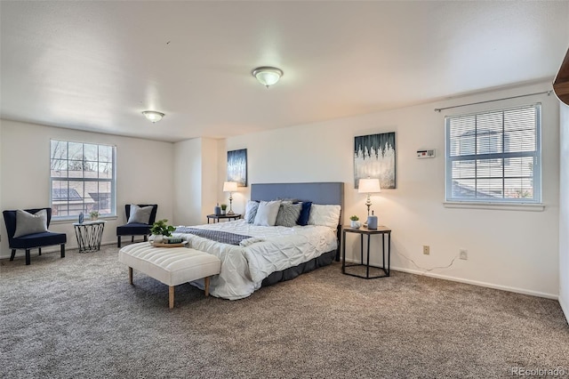 carpeted bedroom featuring baseboards