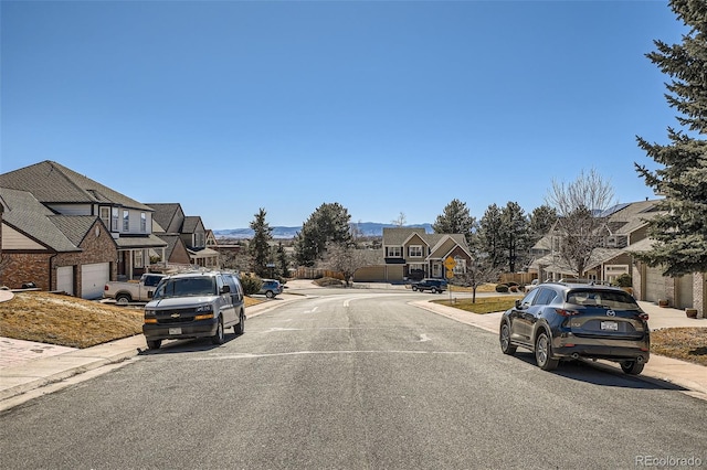 view of road with curbs, sidewalks, and a residential view