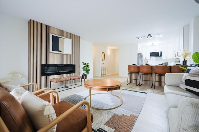 3450 S Poplar St Unit 307, Denver, CO 80224 - living room featuring a glass covered fireplace