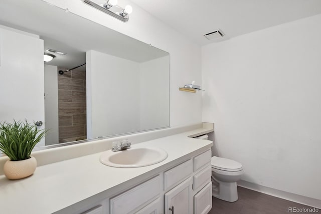 full bathroom with toilet, wood finished floors, vanity, and a shower