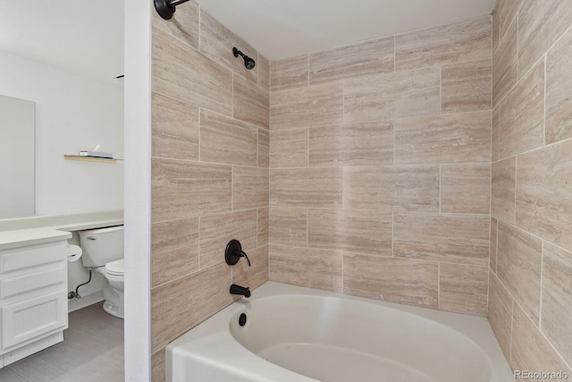 bathroom with vanity, washtub / shower combination, and toilet