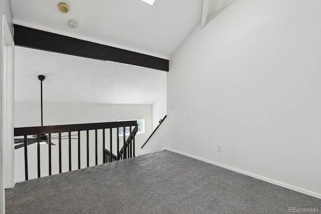spare room with baseboards, a smoke detector, and carpet flooring