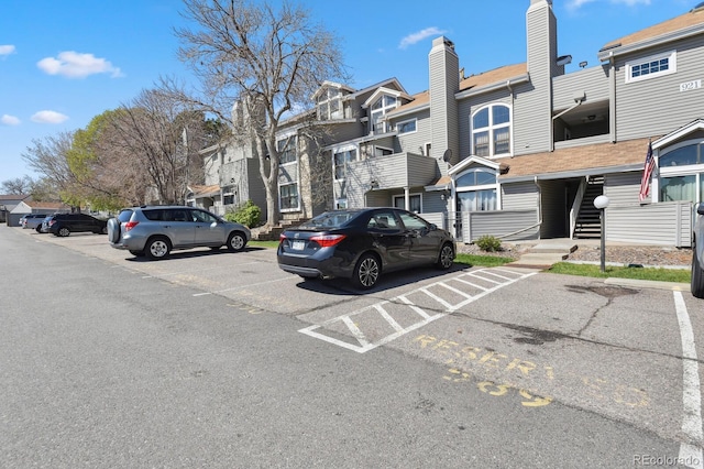 uncovered parking lot with a residential view