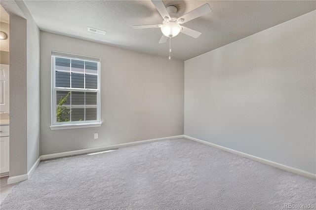 23957 E Rocky Top Ave, Aurora, CO 80016 - spare room with a ceiling fan, light colored carpet, and a textured ceiling