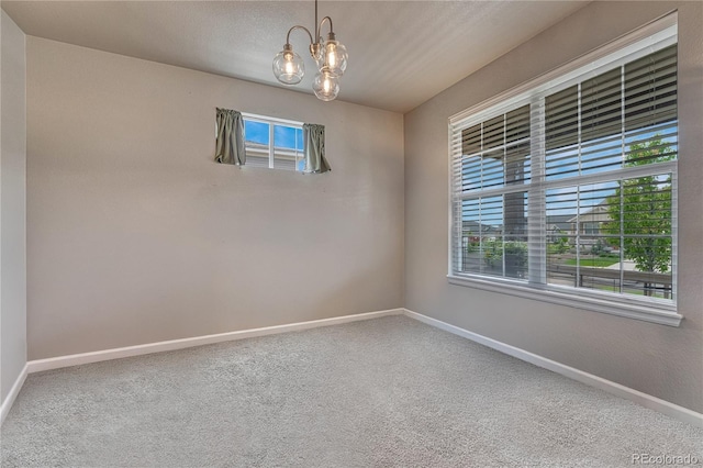23957 E Rocky Top Ave, Aurora, CO 80016 - carpeted empty room featuring a chandelier and baseboards