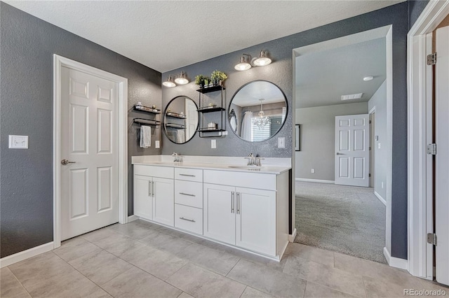 23957 E Rocky Top Ave, Aurora, CO 80016 - full bathroom with a textured wall, double vanity, a textured ceiling, and tile patterned floors