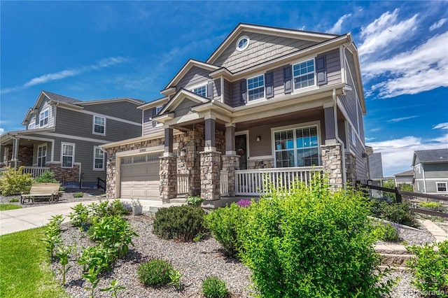 23957 E Rocky Top Ave, Aurora, CO 80016 - craftsman-style home with covered porch, stone siding, driveway, and a garage