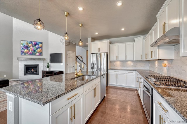 23957 E Rocky Top Ave, Aurora, CO 80016 - kitchen featuring stainless steel appliances, ventilation hood, dark wood-style floors, white cabinetry, and recessed lighting