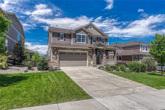 23957 E Rocky Top Ave, Aurora, CO 80016 - view of front of home featuring concrete driveway, a garage, a front yard, and stone siding