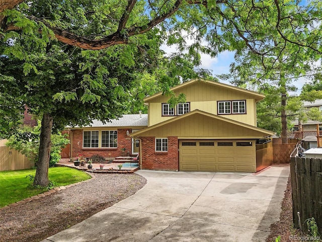 12625 W 66th Cir, Arvada, CO 80004 - tri-level home with concrete driveway, an attached garage, and brick siding