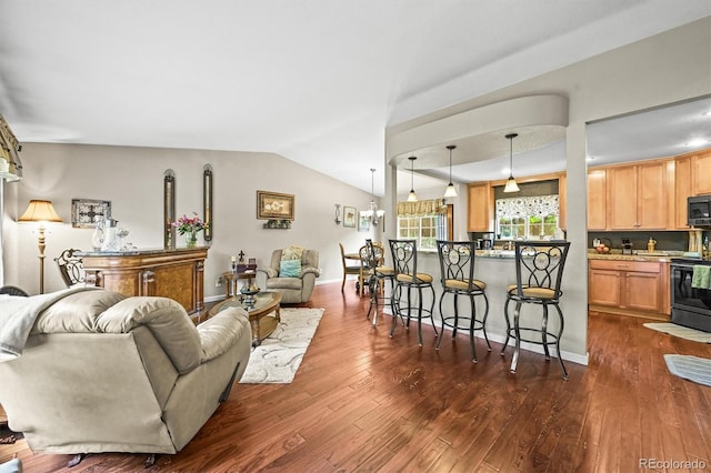 12625 W 66th Cir, Arvada, CO 80004 - living room with dark wood-type flooring and lofted ceiling