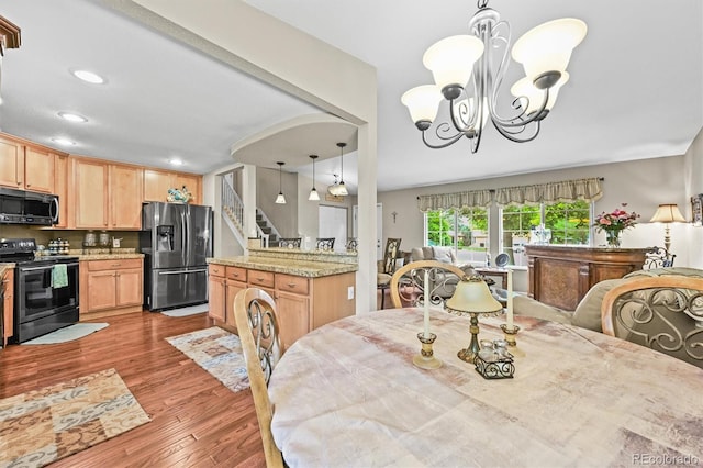 12625 W 66th Cir, Arvada, CO 80004 - dining space featuring stairs, wood finished floors, recessed lighting, and a chandelier