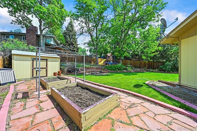 12625 W 66th Cir, Arvada, CO 80004 - view of yard featuring a garden, a playground, and a patio