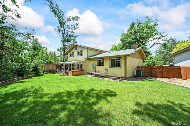 12625 W 66th Cir, Arvada, CO 80004 - back of house with a hot tub, cooling unit, and a patio area