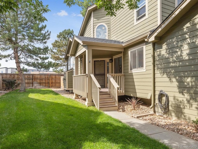 property entrance with a lawn