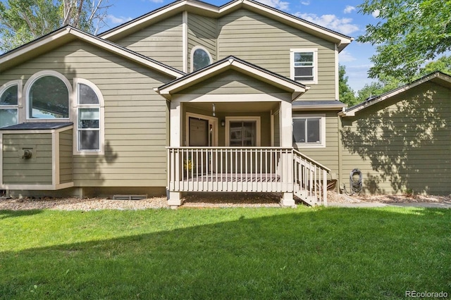 view of front of home with covered porch and a front lawn