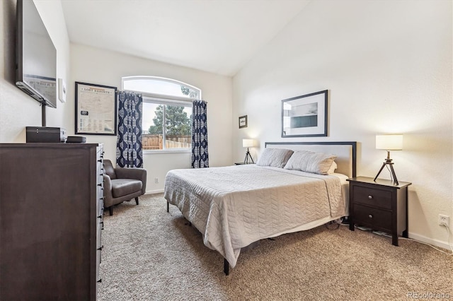 carpeted bedroom with lofted ceiling