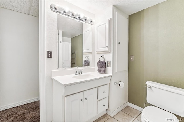 bathroom with tile patterned flooring, vanity, and toilet