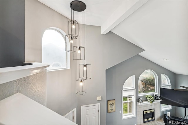 room details featuring a tile fireplace and beam ceiling