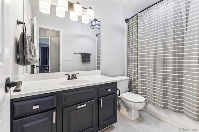 bathroom featuring toilet, vanity, and tile patterned flooring