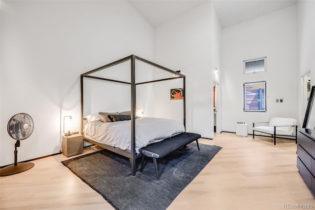 2801 Lawrence St, Denver, CO 80205 - bedroom featuring light wood finished floors and high vaulted ceiling