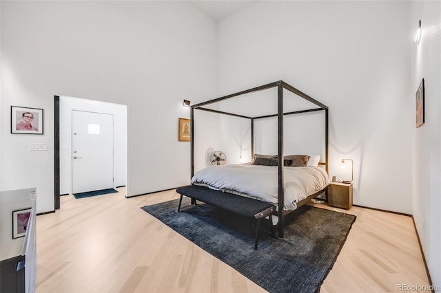 2801 Lawrence St, Denver, CO 80205 - bedroom featuring light wood-type flooring and a high ceiling