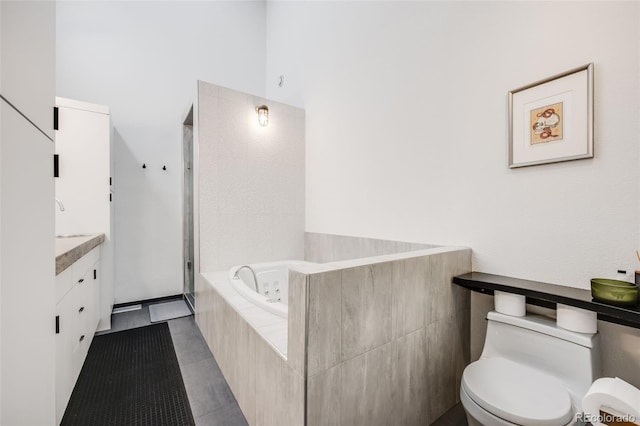 2801 Lawrence St, Denver, CO 80205 - bathroom with a whirlpool tub, toilet, tile patterned flooring, vanity, and walk in shower