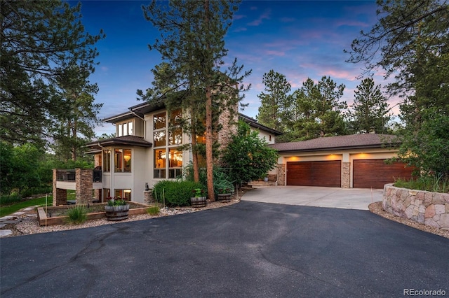 prairie-style house featuring a garage and a balcony