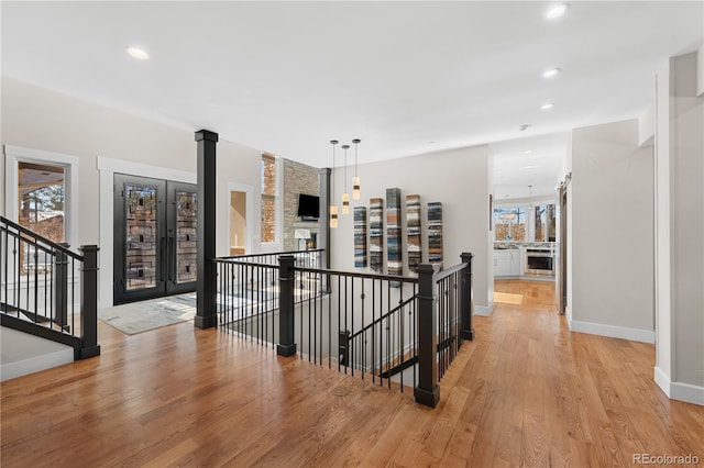 hall featuring light hardwood / wood-style flooring and a healthy amount of sunlight